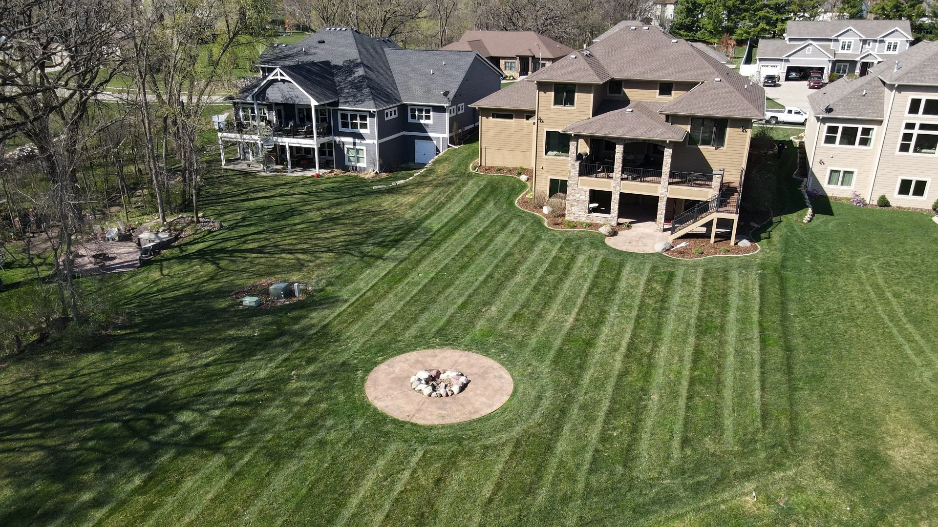 Backyard landscape with fire pit area.