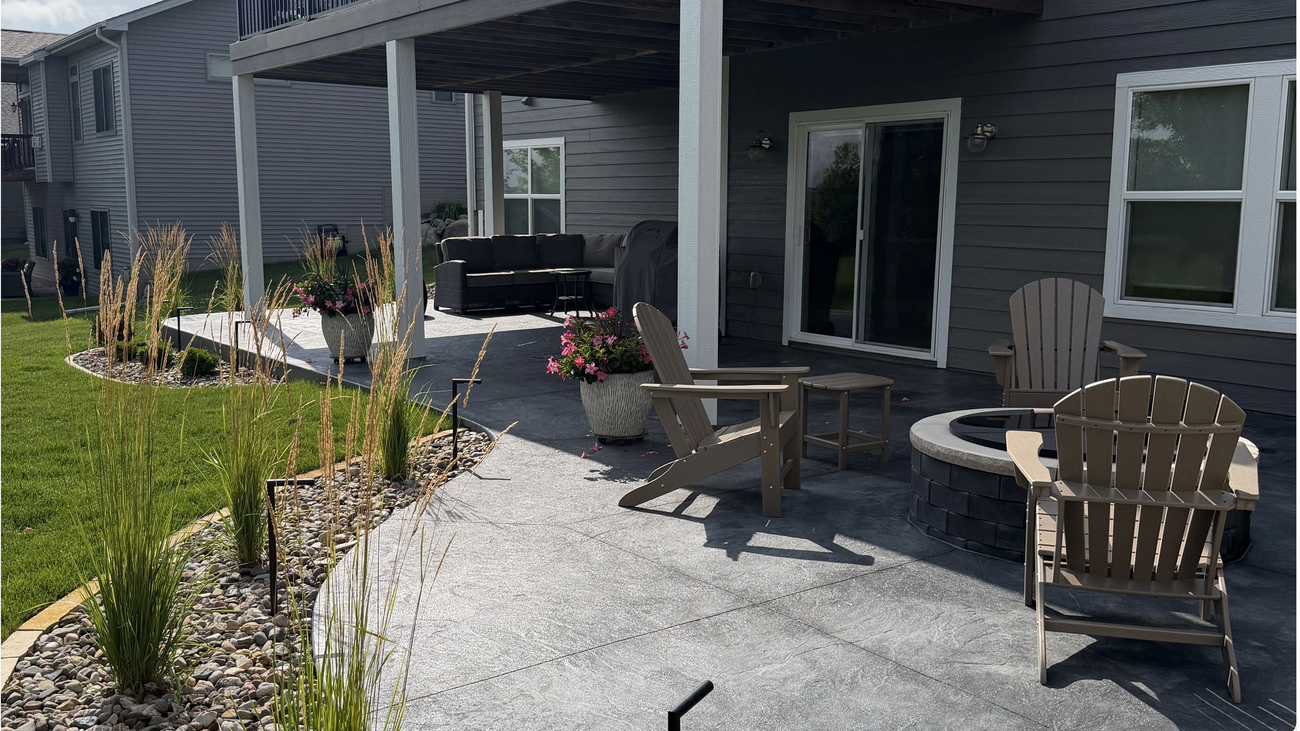 Concrete patio steps surrounded by lush green grass in Waukee, IA.