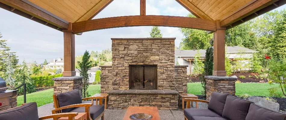 Couch and outdoor fireplace under a pavilion in Waukee, IA.