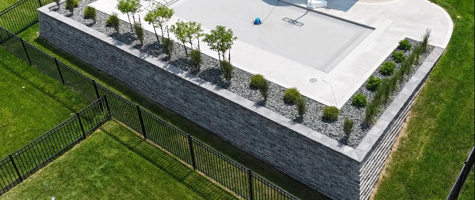 Fence around a retaining wall in Waukee, IA.
