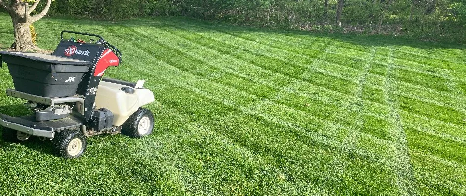 Fertilizer spreader machine on a green lawn in Waukee, IA.