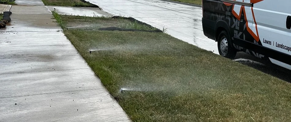 Grass in Waukee, IA, with three sprinkler heads.