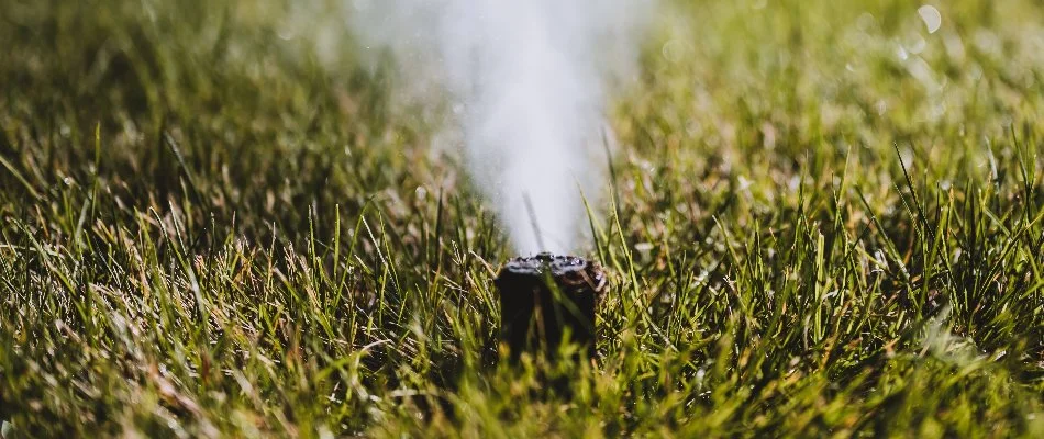 Irrigation sprinkler head in Waukee, IA, during winterization blowout.
