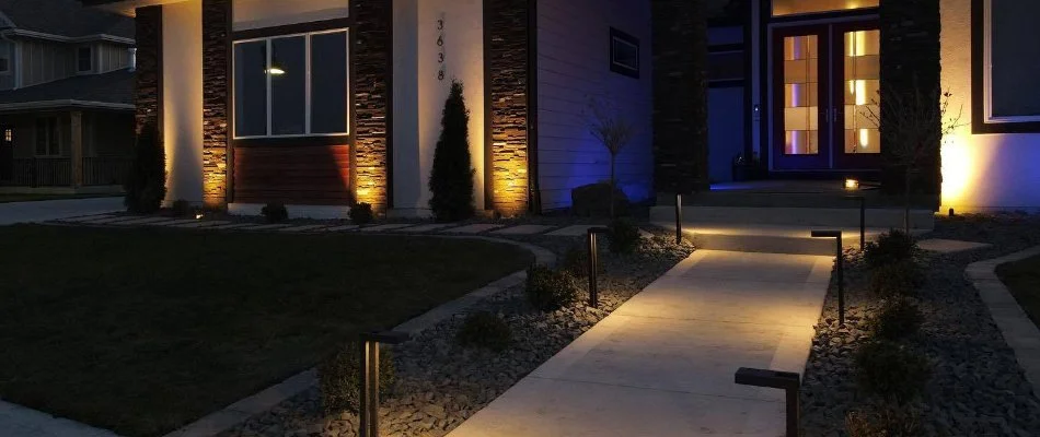 Landscape lighting in a front yard at dusk in Waukee, IA.