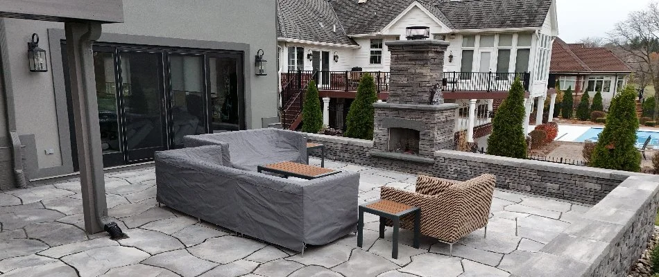 Patio in Waukee, IA, with an outdoor fireplace and seating.