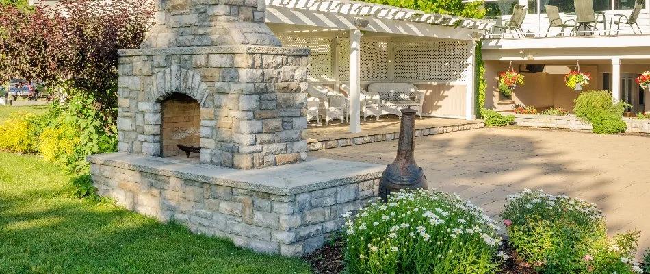 Pergola next to outdoor fireplace in Waukee, IA.