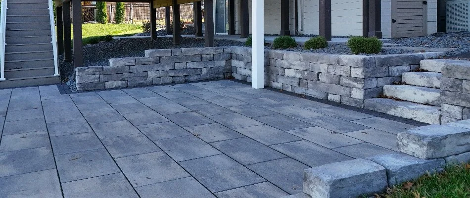 Retaining wall next to a paver patio in Waukee, IA.