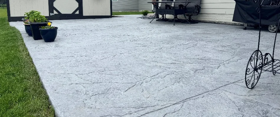 Stamped concrete patio and potted plants in Waukee, IA.