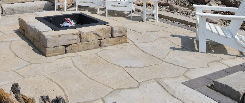 Stamped concrete patio with square fire pit in Waukee, IA.