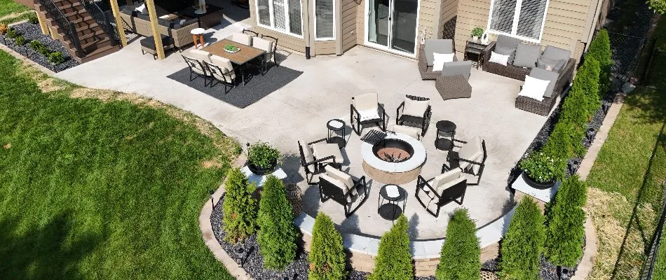 Concrete patio in Panora, IA, with fire pit and outdoor furniture.