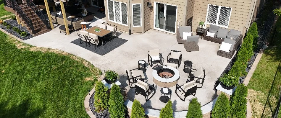 Concrete patio in Adel, IA, with seating and a fire pit.