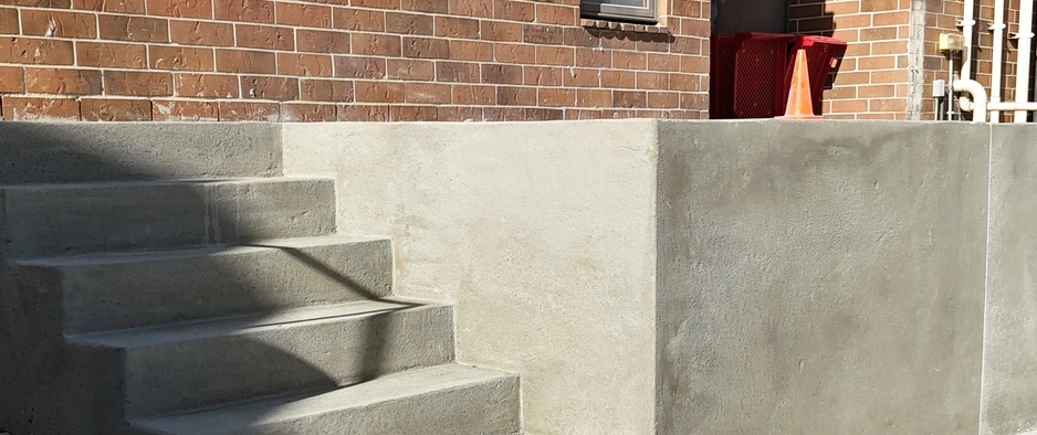 Concrete steps leading to a front door on a property in Waukee, IA.