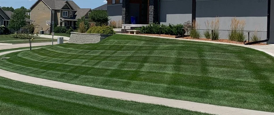 Mowed lawn with stripes on a property in Van Meter, IA.