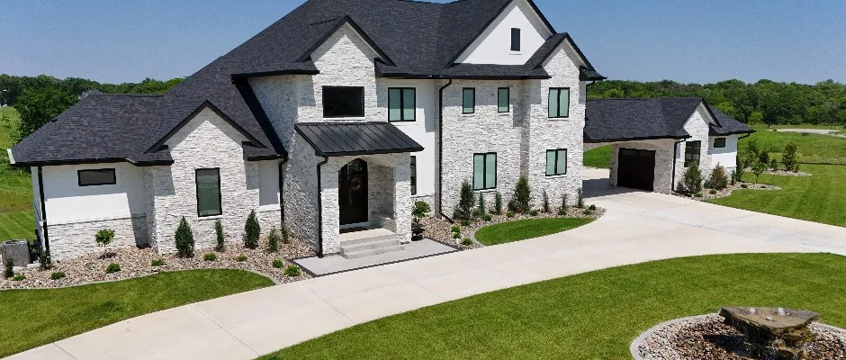 Modern luxury home with landscaped driveway in Waukee, IA.