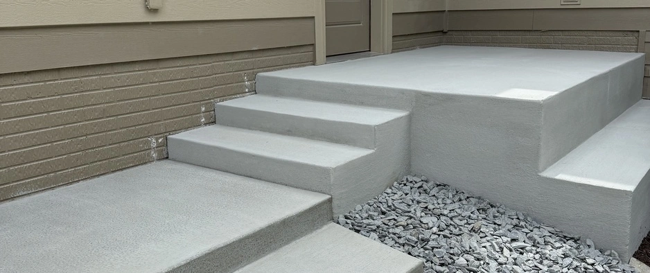 Concrete steps leading to a front door on a property in Waukee, IA.
