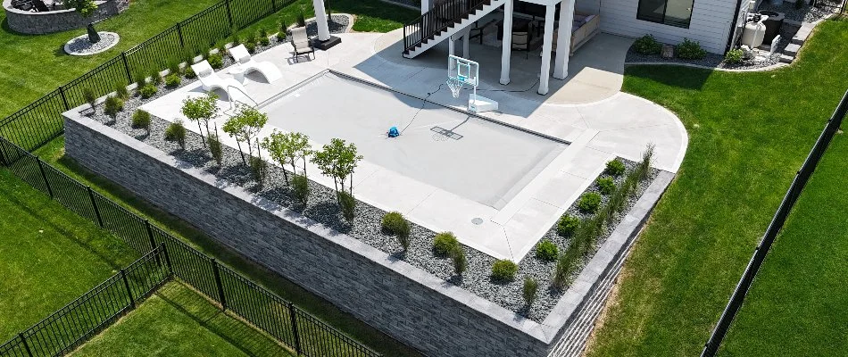Outdoor space in Avon, IA, with a retaining wall, pool, and plants.