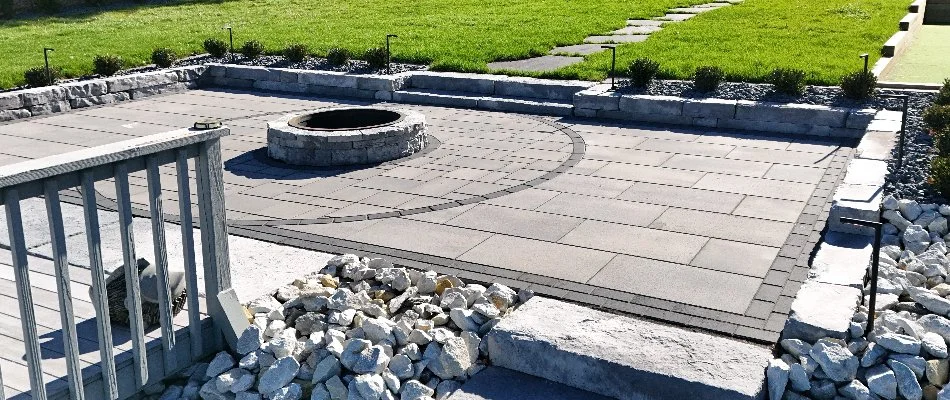 Patio with fire pit and raised planter in Avon, IA.