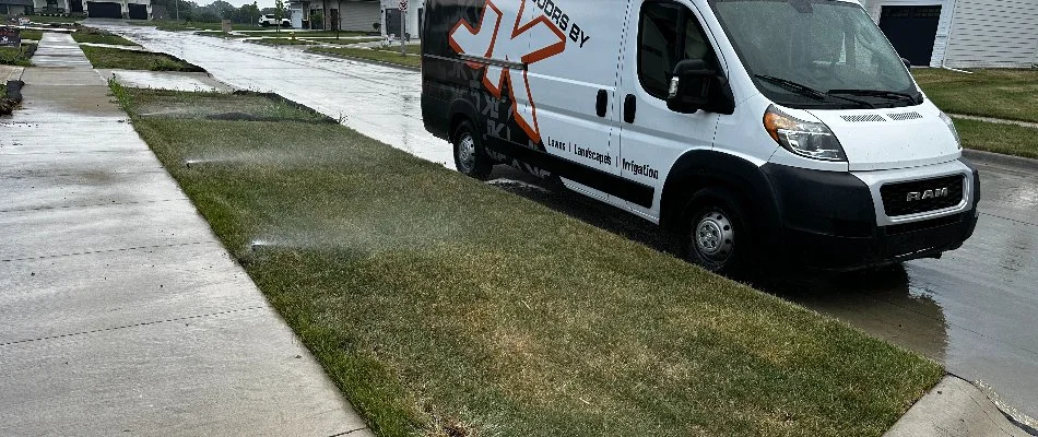 Running sprinklers and a company van in Adel, IA.
