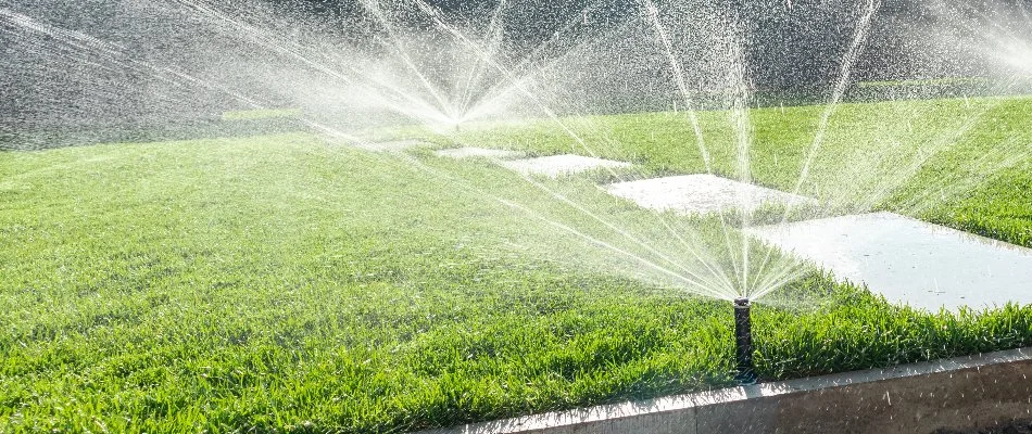 Sprinkler heads on a green lawn in Avon Lake, IA.
