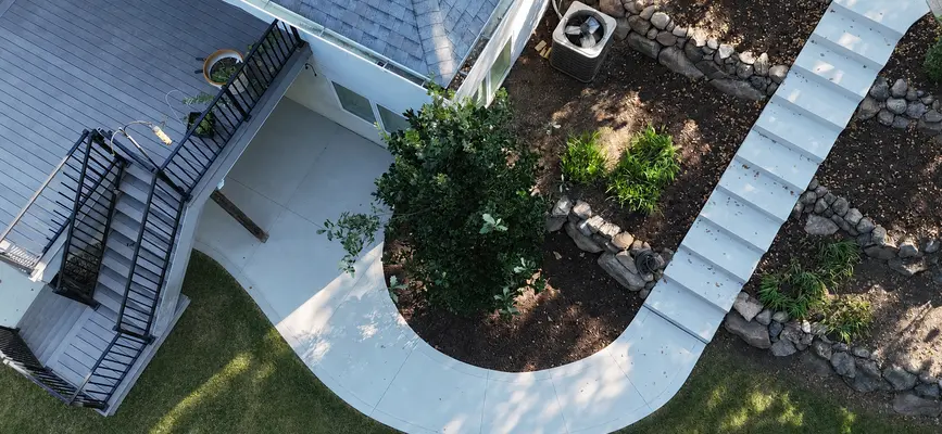 Concrete steps leading to a front door on a property in Waukee, IA.