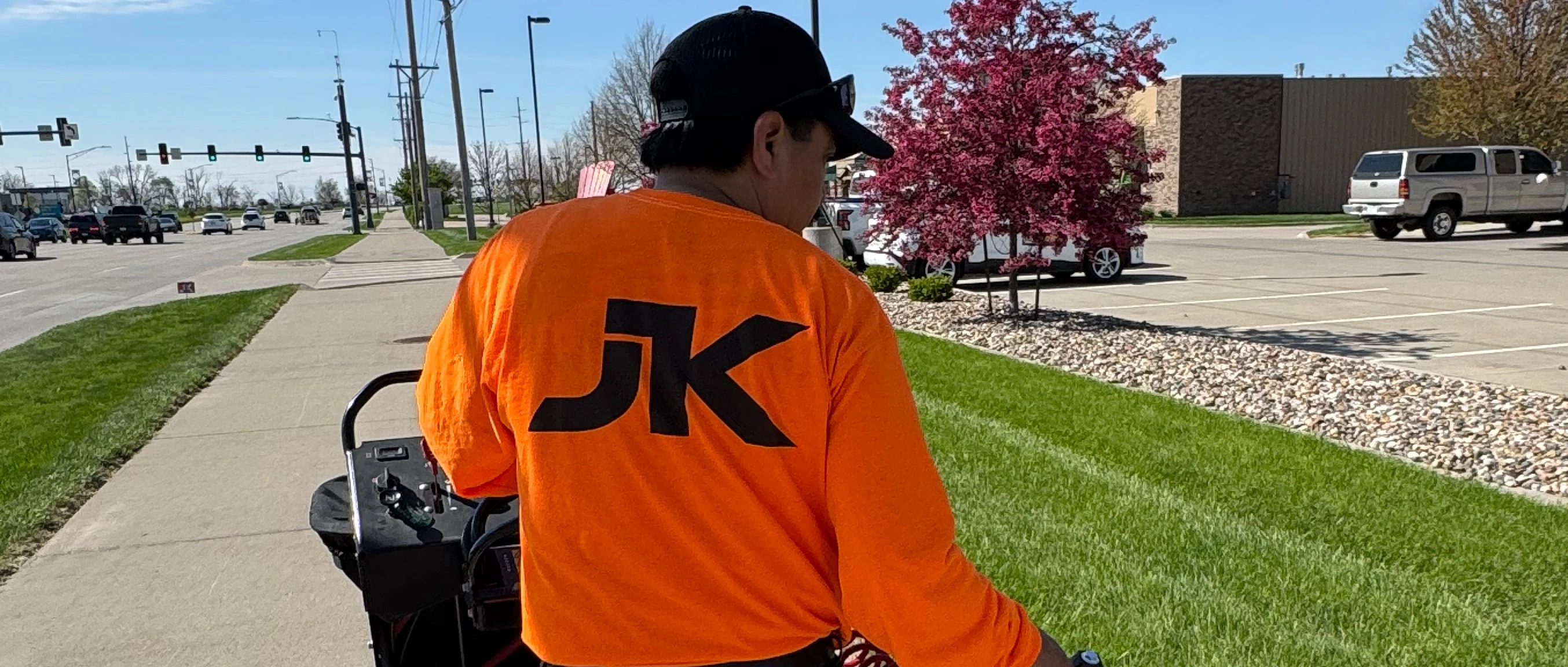 JK worker on a lawn with company uniform.